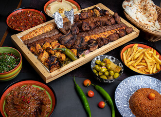 Arabic grilled arabic food dishes kebab, dolma, mansaf, shawarma Turkish and Arabic Traditional Ramadan Mix Vali Kebab Plate inside Adana, Urfa, Chicken, Lamb, Liver and Beef on bread on table