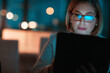 © peopleimages.com - Corporate woman, tablet and reading at night in office for company agenda, research and planning. Digital, tech and working email or report for business results, growth and revenue with deadline