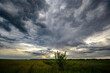 © Orbs production - Dark stormy clouds over a country road, summer time