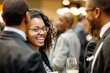 © ELIJA - A businesswoman smiles and connects with other professionals at a business conference