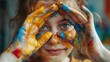 © vefimov - A young girl covered in paint holds her hands over her eyes, looking surprised