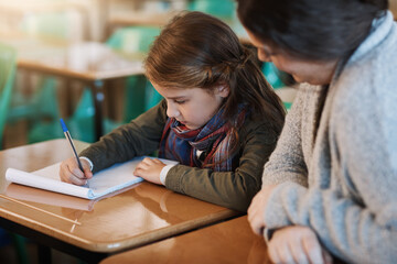 Poster - Teacher, education and help child writing in notebook for learning, study or knowledge in class. Kid, educator or woman with student for assistance, development or support at elementary school lesson