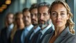 © Vesovic  - An attentive businesswoman is in sharp focus while her diverse team stand in soft focus behind her, symbolizing leadership and diversity