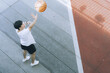 © Nassorn - Shooting basketball. Happy Asian man having fun practice to shoot the ball into the hoop. Young adult basketball player enjoy training exercise, leisure activity, action sport. copy space.