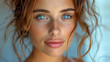 © Pavel Lysenko - A woman with long, wavy hair and freckles stares intensely at the camera. Her blue eyes are the focal point of the photo
