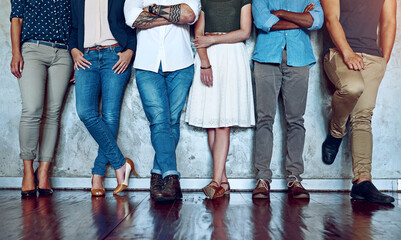 Legs, people and together at wall for recruitment, onboarding and creative team in waiting room. Candidates, diversity or opportunity in line for new work, hiring or job interview in design industry