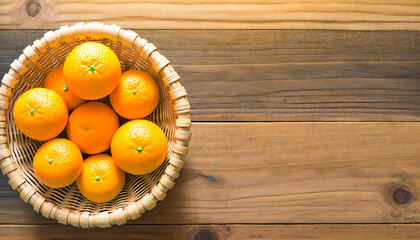 Wall Mural - Tangerines in a wooden bowl, a wooden background