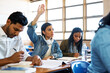 © Seisa/peopleimages.com - University, questions or woman with hand up in classroom for exam, test or help with school project. Education, learning and student with palm sign for attention in college, presentation or lecture