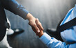 © Delmaine/peopleimages.com - Above, handshake and crm meeting for b2b deal, discussion and business with company contract. Office, people or employees with teamwork or collaboration in workplace for finance or accounting