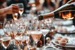 © Marina Demidiuk - Party and holiday celebration concept. Many glasses of champagne on the table in the restaurant. Waiter pouring white sparkling wine from bottle to glass. Drinks Serving. Weekend festival, wedding