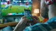 © dobok - Man Watching Live Football Match Smartphone