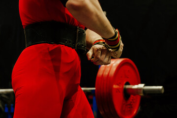 Wall Mural - close-up athlete in red singlet on background bench press barbell