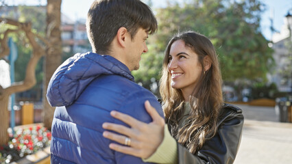 Poster - A loving couple embraces on a sunny urban street, exuding warmth and happiness.