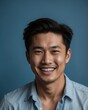 © sevenSkies - blue background studio portrait of smiling handsome asian guy model with clear smooth skin and white teeth