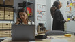 © Krakenimages.com - Two women, possibly investigators, work diligently in a cluttered office, one intently making a phone call.