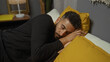 © Krakenimages.com - Handsome hispanic man sleeping in a cozy bedroom at home, lying peacefully on a bed with yellow bedding.