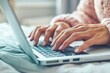 © Danko - Close up of business woman hand typing on laptop computer keyboard