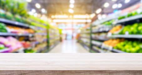 empty wooden table with a blurry grocery supermarket background in a shopping mall background