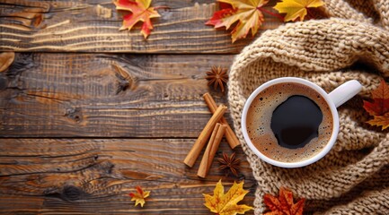 Wall Mural - Cup of Coffee on Wooden Table With Fall Leaves and Cinnamon Sticks