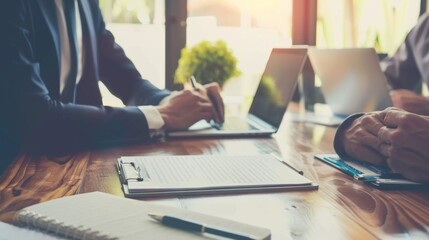 Aufkleber - Two men are sitting at a table with laptops and a clipboard