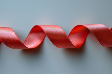 Poster - Simple image of a red ribbon creating a spiral shape, set on a smooth white surface,