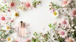 © TheWaterMeloonProjec - Spring flowers arrangement with perfume bottle on white background Top view with space for text