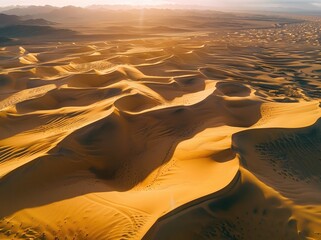 Wall Mural - Aerial view of desert dunes, ripples in the sand texture, golden hour lighting, high resolution photography.