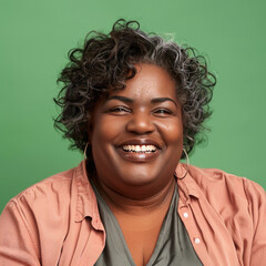 Wall Mural - Portrait of a Smiling Overweight African American Woman on a Green Background