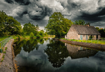 Poster - Beautiful countryside. Old abandoned water mill and stormy sky