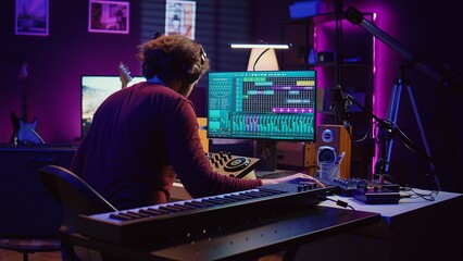 Aufkleber - Music engineer using usb stick to edit and add sound effects on audio recording, adjusted volume levels. Artist doing mixing and mastering technique on soundboard, plays piano. Camera B.
