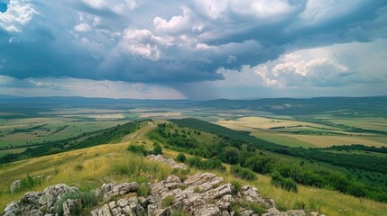 Wall Mural - View of summer rural landscape from mountain top with cloudy sky and changing weather