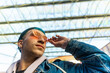 © ADDICTIVE STOCK - Stylish young man with blue hair and red sunglasses in urban setting