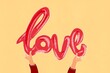© ADDICTIVE STOCK - Illustration of hands holding a stylized love text