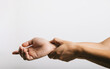 © sorapop - A portrait of a man, looking sad, as he endures wrist pain, possibly from carpal tunnel syndrome. Studio shot isolated on white background, illustrating health care and the medical concept.