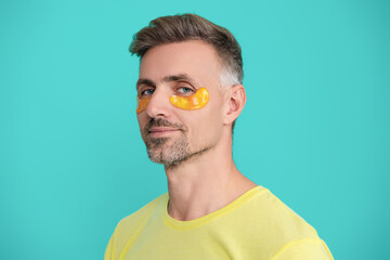 mature man with applied moisturizing under eye anti wrinkle patch. facial beauty skincare. man with 