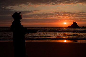 sunset silhouette of a person on the beach