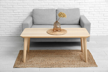 Poster - Vase with dried hydrangea and mat on coffee table near couch