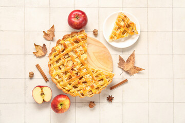 Wall Mural - Wooden board with delicious apple pie and plate of piece on white tile background