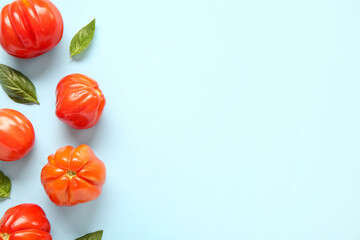Wall Mural - Fresh ripe tomatoes and basil on blue background