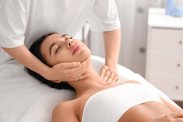 Wall Mural - Young woman having facial massage in salon, closeup