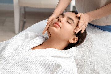 Wall Mural - Beautiful woman having facial massage in salon, closeup