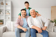 © Pixel-Shot - Teenage boy with his dad and grandfather on sofa at home