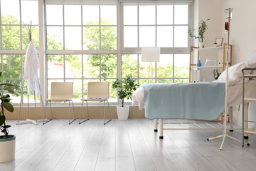 Canvas Print - Interior of hospital ward with bed, chairs and window