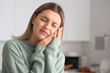 Canvas Print - Young woman suffering from tooth ache at home