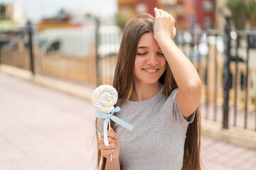 Wall Mural - Teenager girl holding a lollipop has realized something and intending the solution