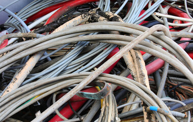 Sticker - many used old electrical cords in a recycling container for copper recycling