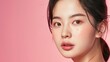 © songwut - A beautiful Korean girl, with a small face and V-shaped jawline, modeling skincare products in a professional studio, showcasing her flawless skin.