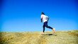 © STOCK PHOTO 4 U - Man Running on Rocky Terrain Under Clear Blue Sky, Outdoor Fitness and Adventure Concept