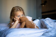 © evgeniia_1010 - A little blonde girl with her plush brown teddy bear on a big bed in an amazingly beautiful hotel room.