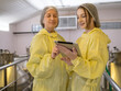 © Singh - Engineer technicians staff woman two person smiling talk and inspect check quality control working job in wine vats barrels on modern technology winemaking factory  industry plant in warehouse.